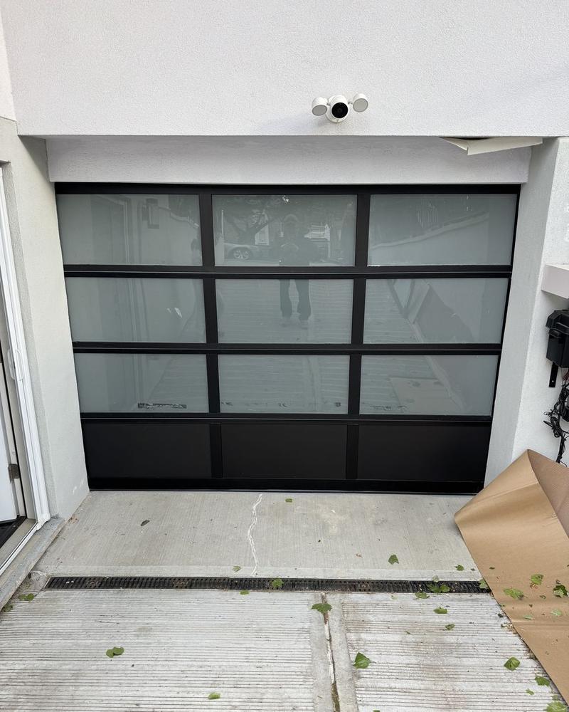 Black aluminum garage door with frosted glass panels