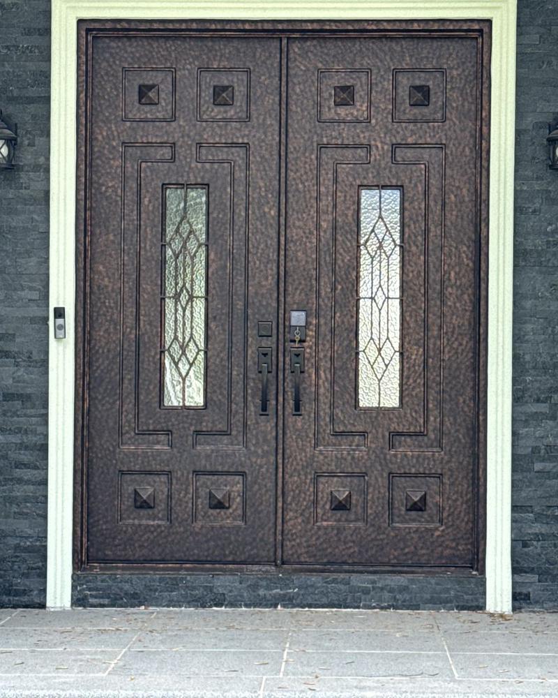 Double doors with leaded glass inserts in a stone entry