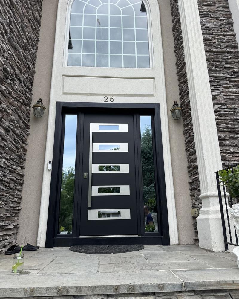 Entry door with five horizontal glass lites, stone facade