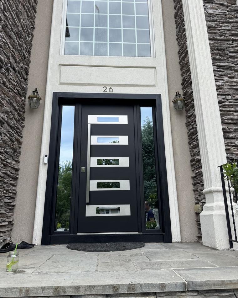 Replacement entry door with five glass lites in a stone facade